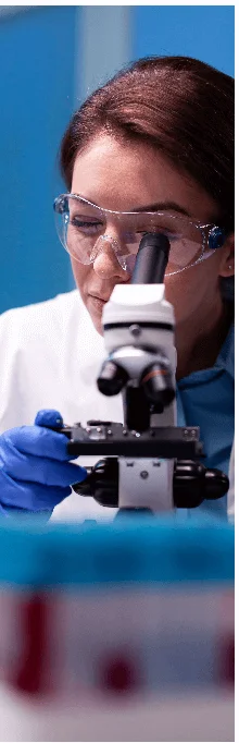 Scientist examining a sample under a microscope